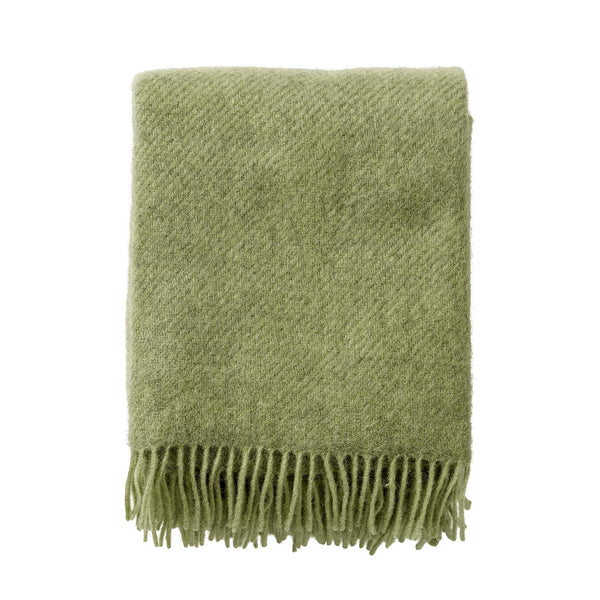 Klippan Gotland brushed wool throw in pear green, folded on a white background
