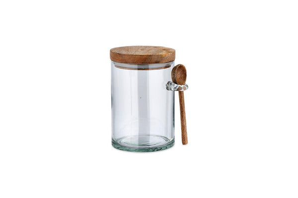 Nkuku Kossi large recycled glass storage jar with mango wood lid and wooden spoon on white background