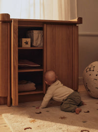 ferm LIVING Skye rug styled on a wooden floor in a child's room