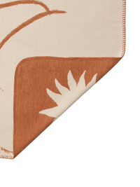 Folded ferm LIVING Skye blanket showing both sides of the reversible design