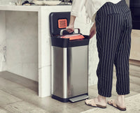 Titan 30L trash compactor with compaction handle raised in a kitchen