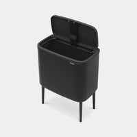 Bo Touch Bin matt black viewed at an angle showing slim legs