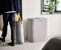 Tota Trio laundry basket in a bedroom setting