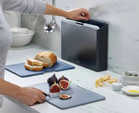 Folio grey chopping board being pulled from the tiered case by its steel bar