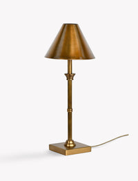 Kelmscot antique brass lamp styled on a desk