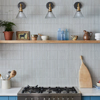 Pair of Brooklyn glass funnel brass wall lights in a blue country kitchen