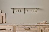 Basti shelf styled above a wooden sideboard