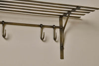 Close-up of a movable antique brass hook on the Basti shelf