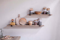 Ibo shelves styled on a wall with kitchen storage jars and boards