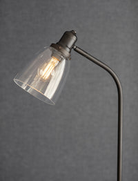 Hoxton antique bronze floor lamp beside a reading chair