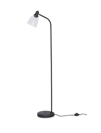 Hoxton dome floor lamp lit in a living room corner