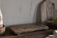Kaveeta board with a small bowl of salt on a dark wood table