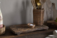 Kaveeta serving board styled on a rustic kitchen shelf