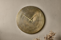 Okota wall clock hung on a warm plaster wall