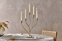 Palani candelabra as a centrepiece on a linen-covered dining table