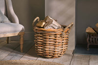 Rattan Chunky Basket filled with firewood beside an armchair