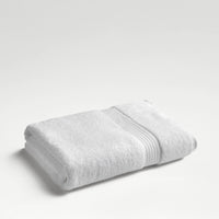 Christy Supreme Hygro bath sheet in white, folded on a neutral background
