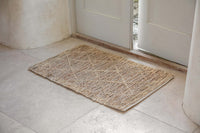 Vandi jute doormat lying in a bright doorway