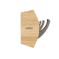 Umbra Flip 8 rail in natural and nickel with coats hanging in an entryway