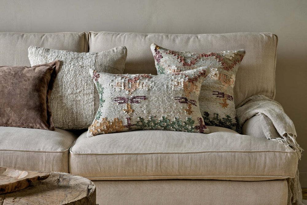 Handwoven cushions and soft textiles styled on a natural linen sofa