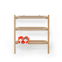 Wireworks Heel Bar oak leaning shoe rack with a pair of trainers on the bottom shelf