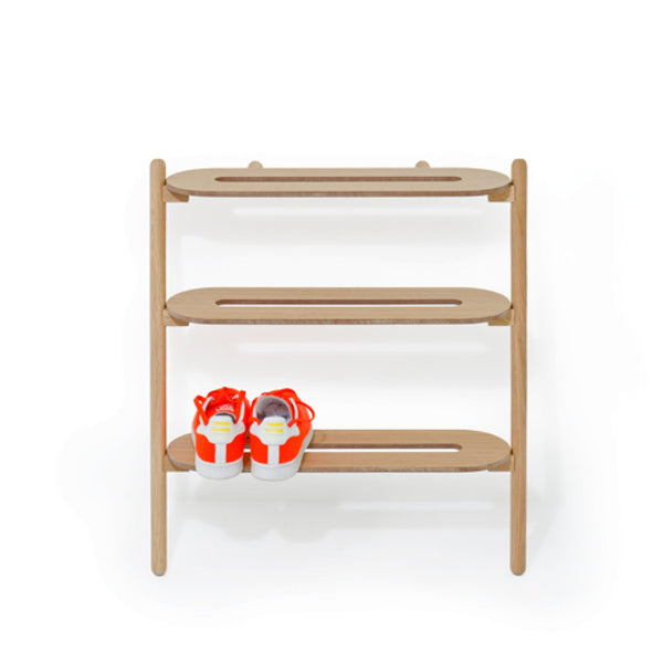 Wireworks Heel Bar oak leaning shoe rack with a pair of trainers on the bottom shelf