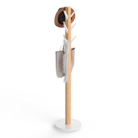 Umbra Flapper freestanding coat rack in white and natural wood with hat and bag on flip-down hooks